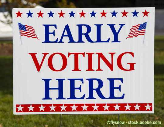 Early Voting Here sign. Take advantage of early voting, absentee voting and mail voting opportunities to make your voice heard. COVID-19