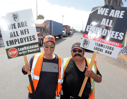 Port workers on strike for being misclassified, which AB addresses