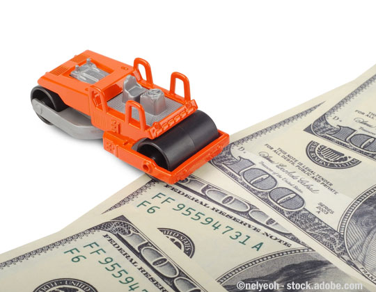 Toy paver machine, U.S. money. VMT tax on trucks is being considered by a federal agency.