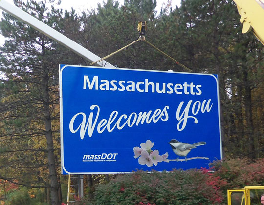 Massachusetts Welcomes You sign going up CDL
