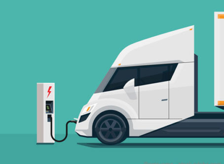 Graphic, electric-powered truck at charging station