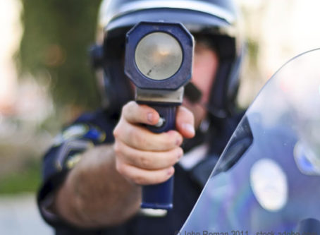 Law enforcement officer with speed radar gun