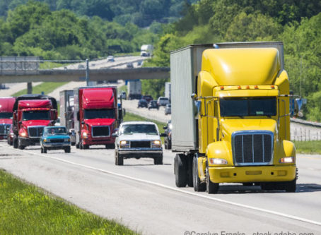 A yellow semi leads a packed line of traffic down an interstate in Tennessee.