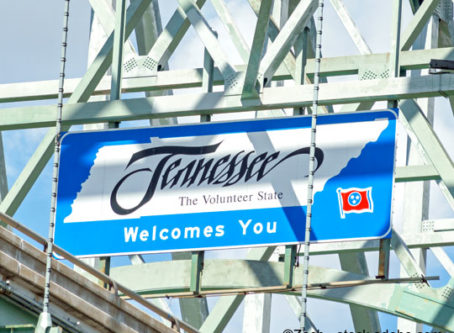 Tennessee welcome sign hanging from a steel bridge