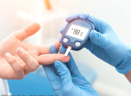 Doctor checking blood sugar level with glucometer for diabetes