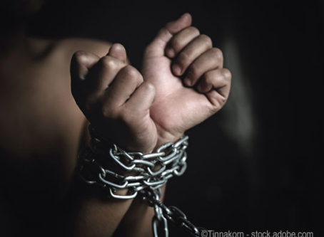 Human trafficking, woman in chains image