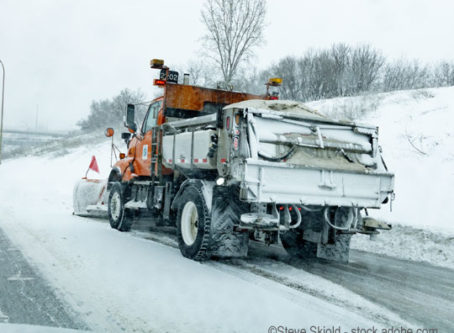 Winter weather, truck plowing snow from the highway shoulder. St Paul Minnesota MN USA