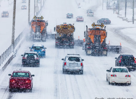 Snowplows clearing the highway in winter storm