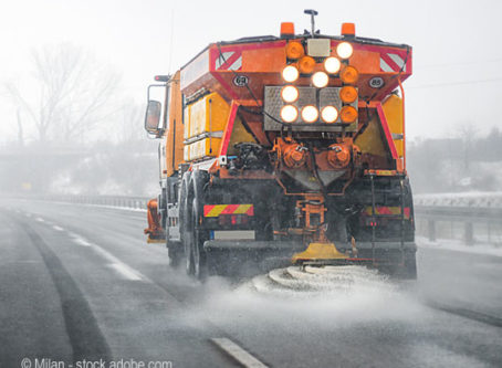 icy winter weather, snow plow spreading deicer