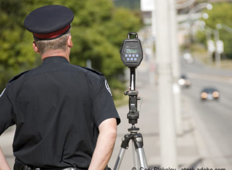 Officer with radar ticket camera, speed trap