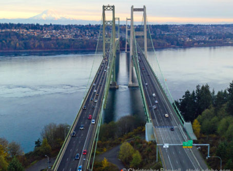 Aerial view Tacoma Narrows Bridges over Puget Sound, Mount Rainier in the background. By Christopher Boswell