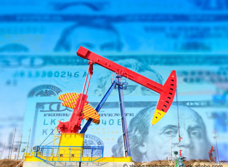 Oil pumpjack on background of US dollar