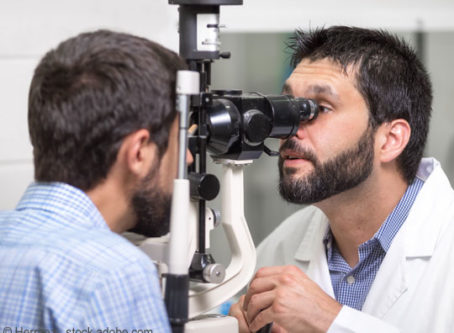 Ophthalmologist is checking the eye vision of young man Vision test, vision standards.