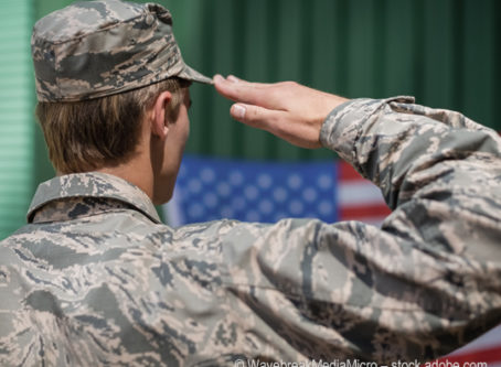 Military veteran salutes U.S. flag. Photo by WavebreakMediaMicro