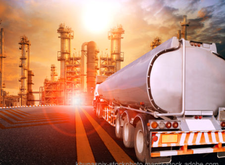 Energy outlook graphic --oil container truck and heavy petrochemical industries plant . Graphic by stockphoto mania