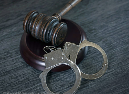 Handcuffs and gavel Photo by Aerial Mike