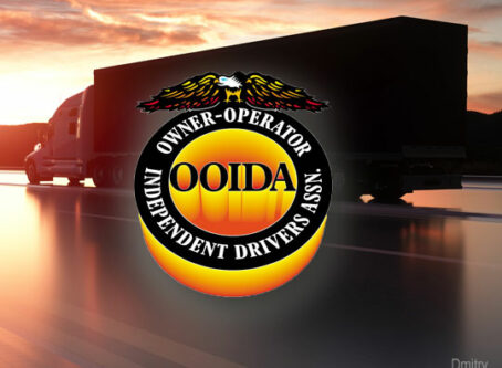 OOIDA, truck silhouetted on highway. Photo by Dimitry