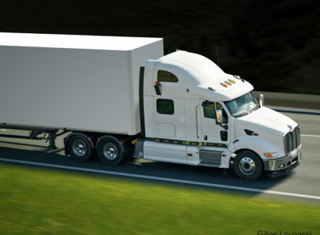 Speed limiters contradict driver retention goals. White truck photo by Gilles Lougassi