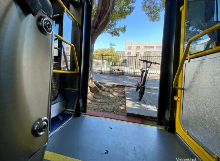 Electric bike rental thru doors of bus in Los Angeles, California, 2021. Image by Vesperstock
