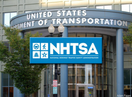 NHTSA, National Highway Traffic Safety Administration logo over U.S. DOT building background by Adam Fagen
