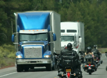 Motorcycles, tractor-trailers on highway. Photo by cascoly2