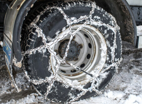 Winter chains on tractor-trailer tire. Image by Angela Bragato