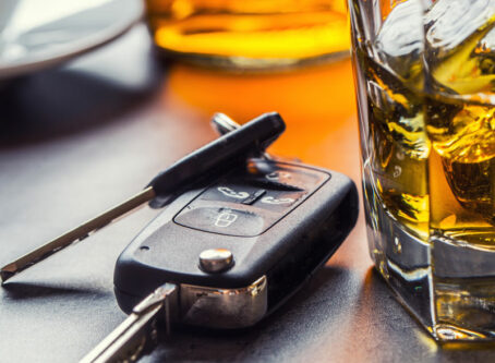 Drinking and driving.Car keys and glass of alcohol on table. Image by weyo